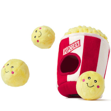 Red popcorn container plush toy with two yellow smiley face balls on a white background